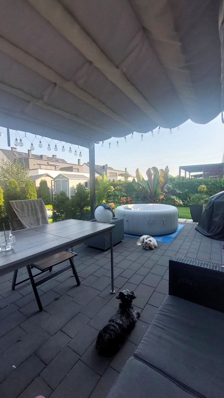 zadaszony taras z meblami ogrodowymi i jacuzzi przy mieszkaniu w Opolu Chmielowicach